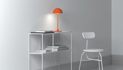Orange table lamp on white table