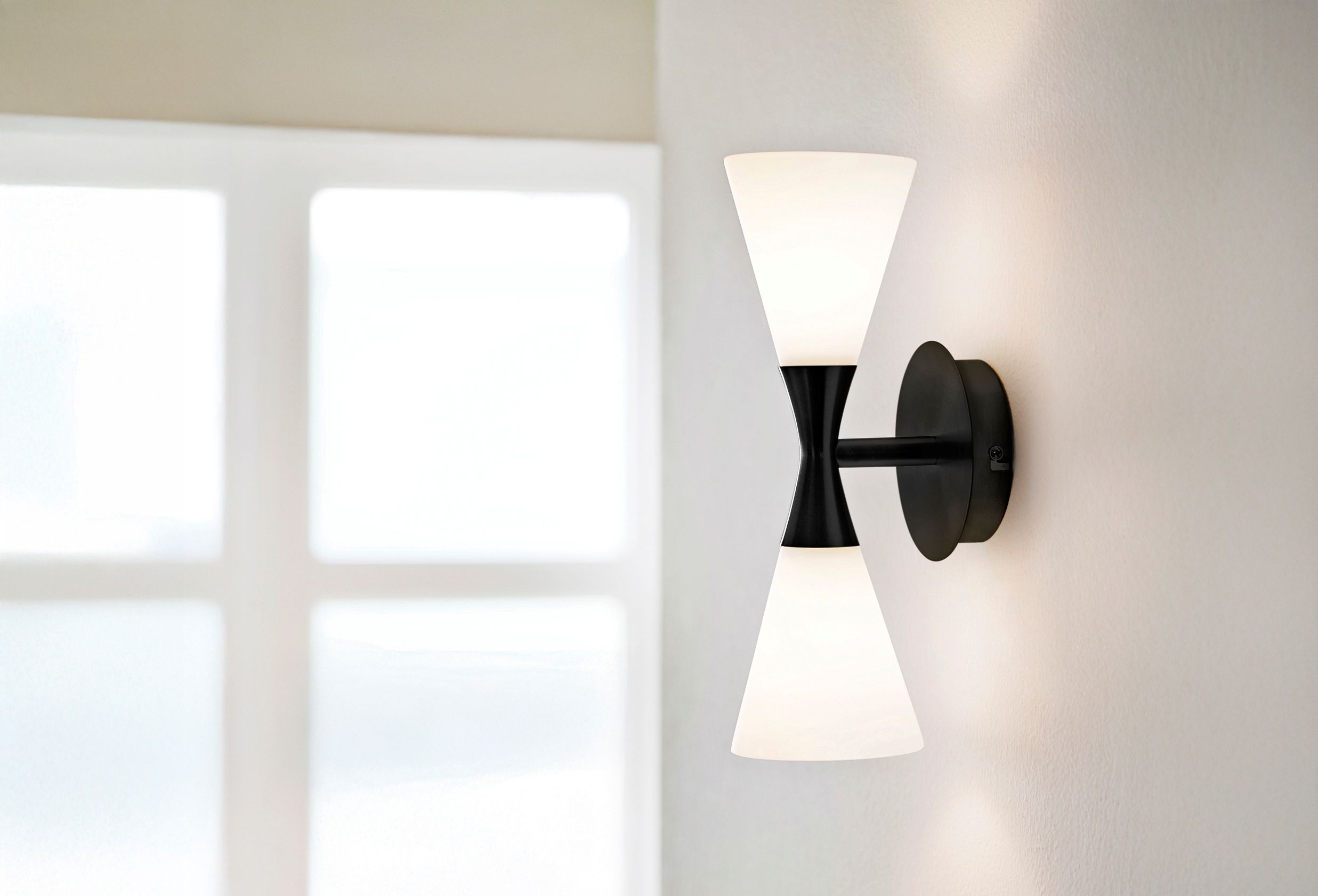 Black wall lamp by the window