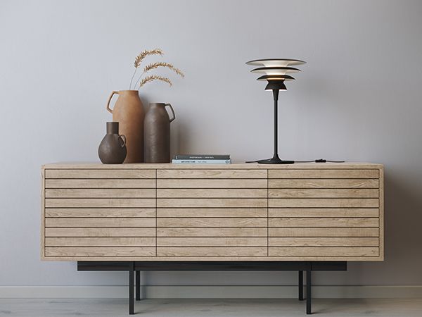 Black table lamp with three shades on a sideboard in oak