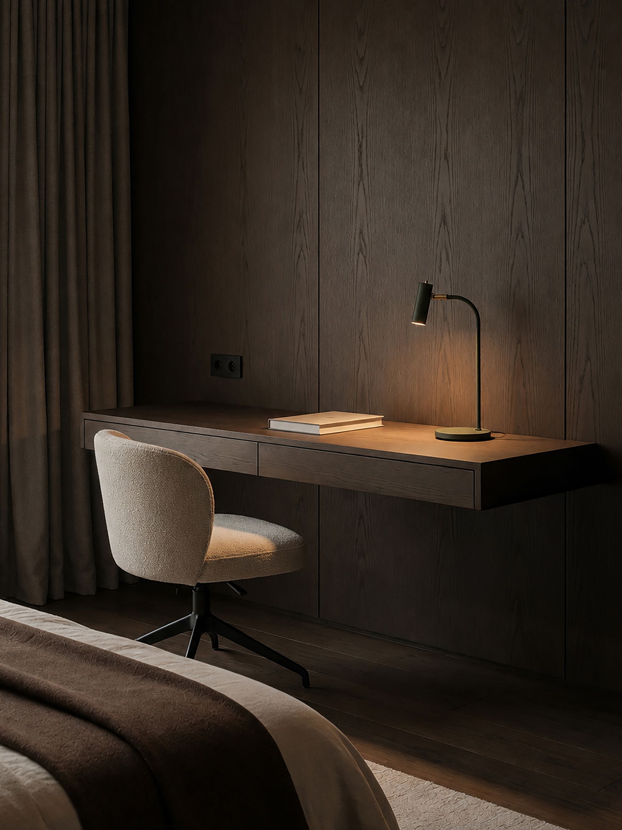 Slender table lamp in bottle green and brass on a desk