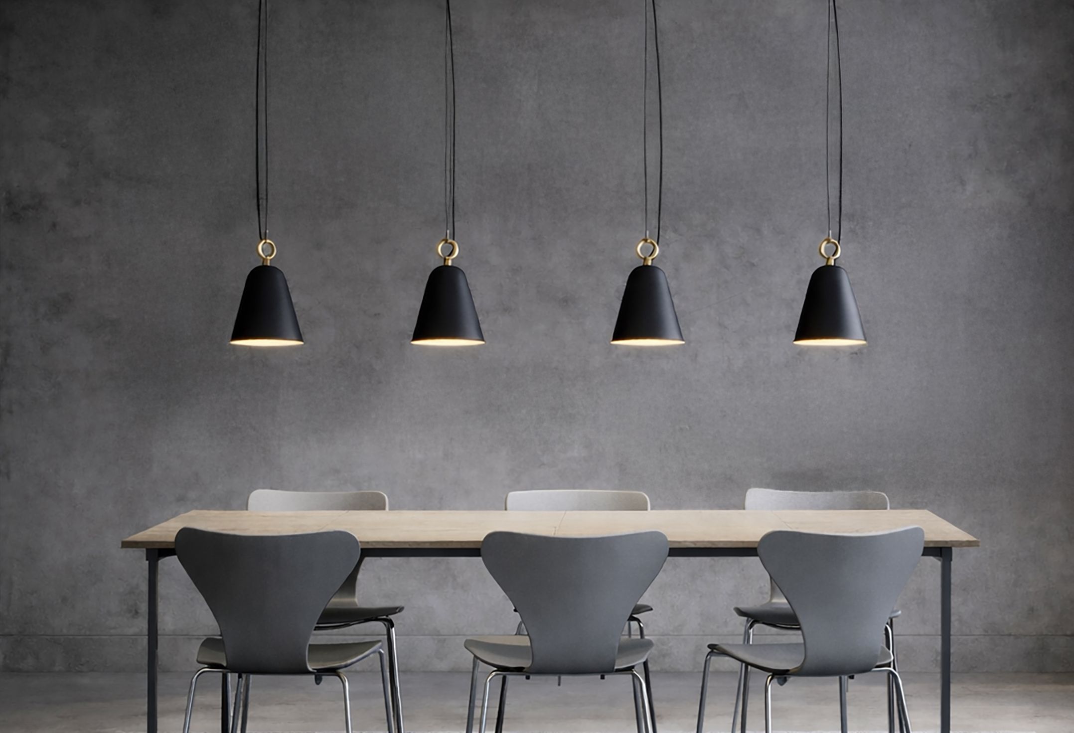A kitchen with table, chairs and lamps