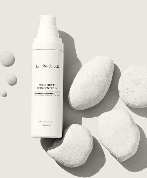 bottle of Josh Rosebrook Bioidentical Collagen Serum on a white background with white stones