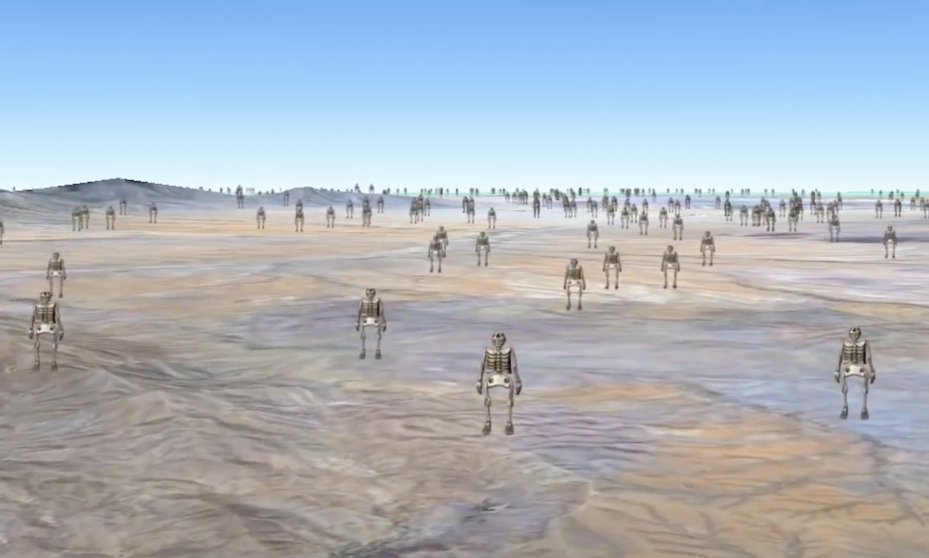 Numerous iron skeleton sculptures stand on a landscape with distant mountains under a clear, blue sky.