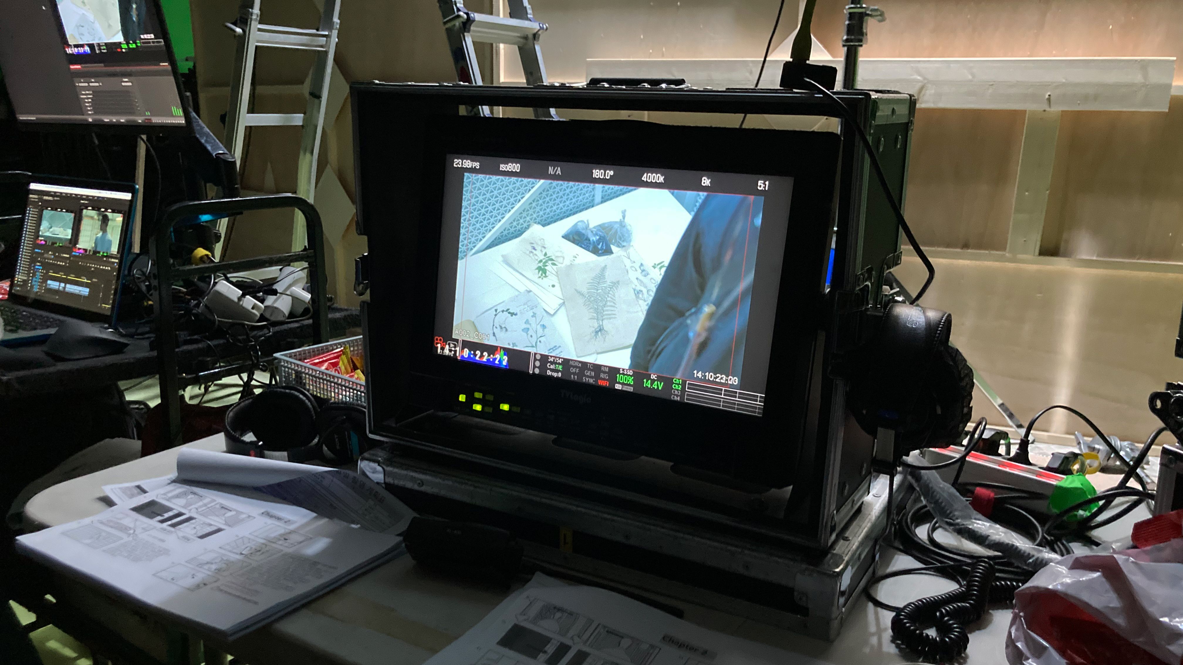 A video display placed on a desk, portraying a professional working environment scene.