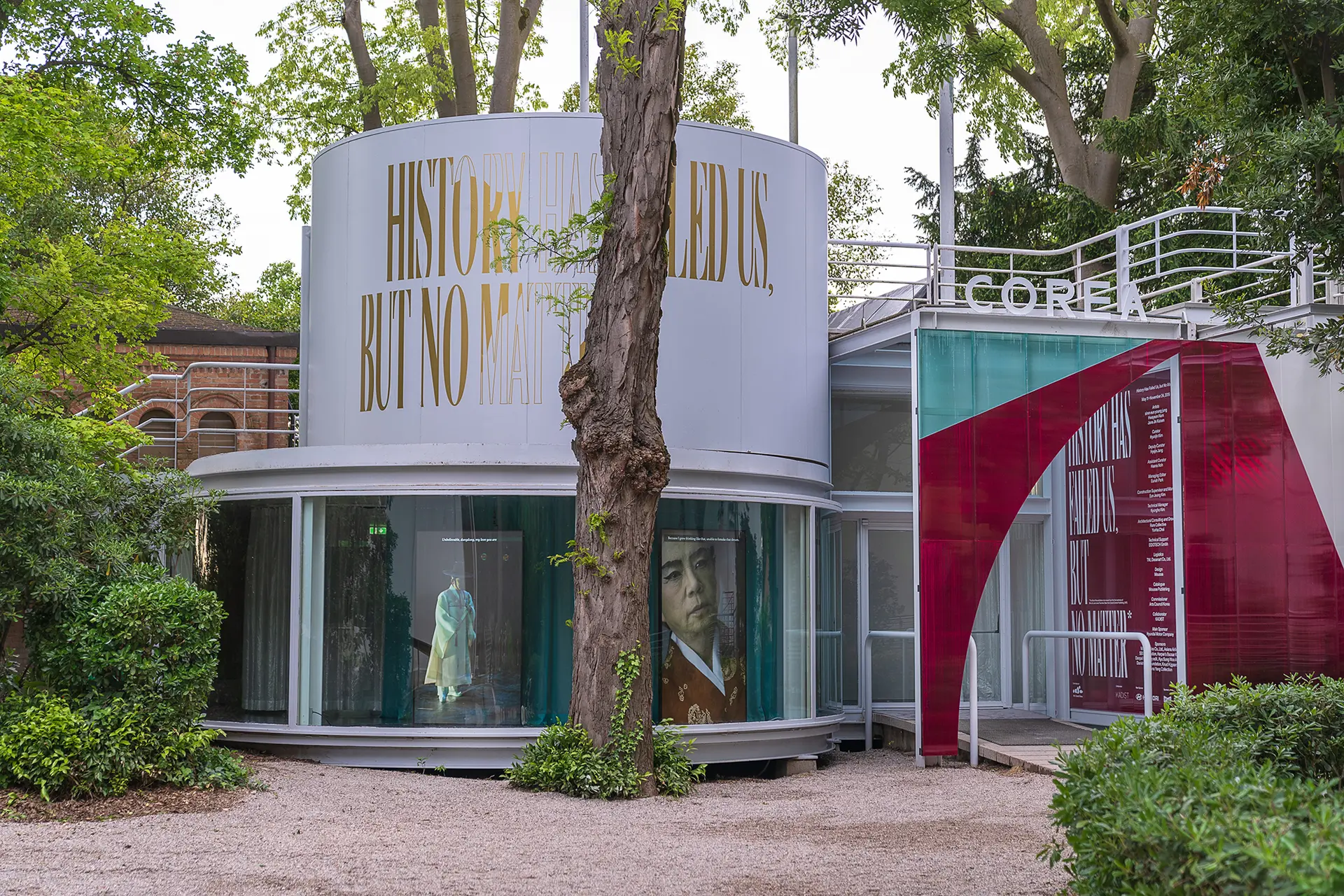 The exterior of the Korean Pavilion at an international exposition, with large text "HISTORY HAS FAILED US, BUT NO MATTER."