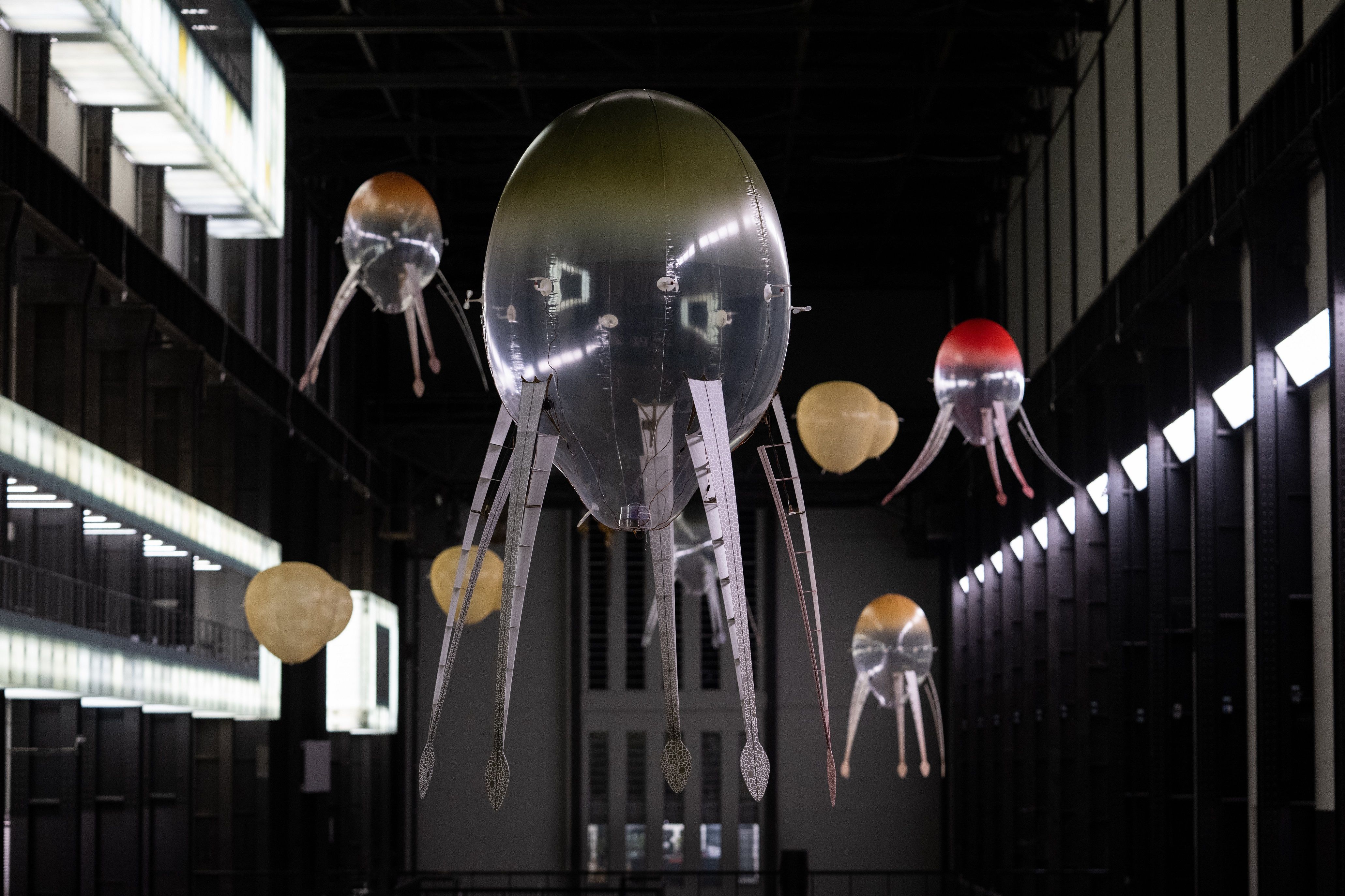 Ceiling installation designed in an industrial style, featuring lamps shaped like an octopus with snake-headed tentacles, ...
