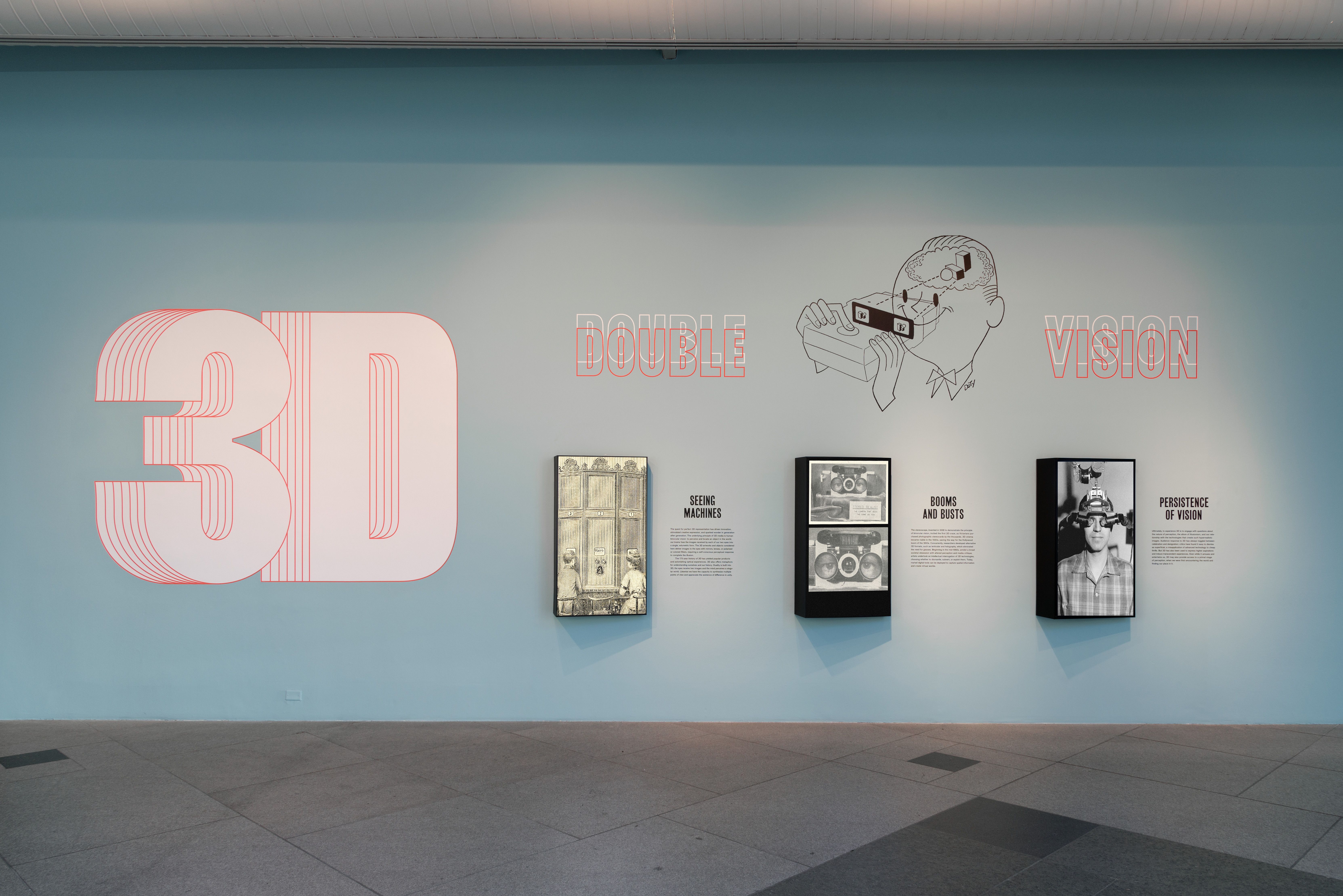 An exhibition titled "3D: Double Vision" displayed on a light blue wall at the Los Angeles County Museum of Art.