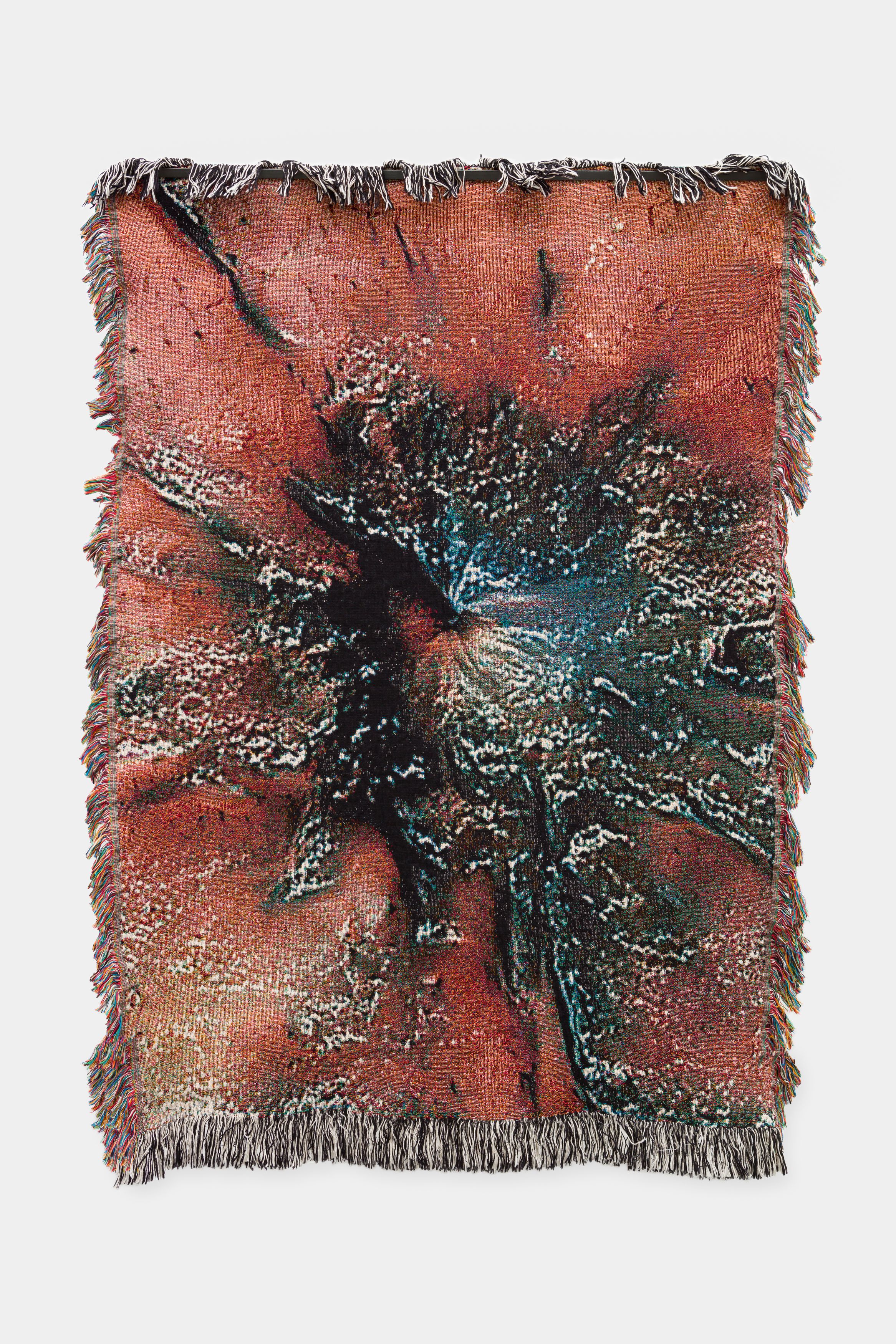 A textured tapestry with an abstract design featuring a burst-like pattern in warm, earthy tones.