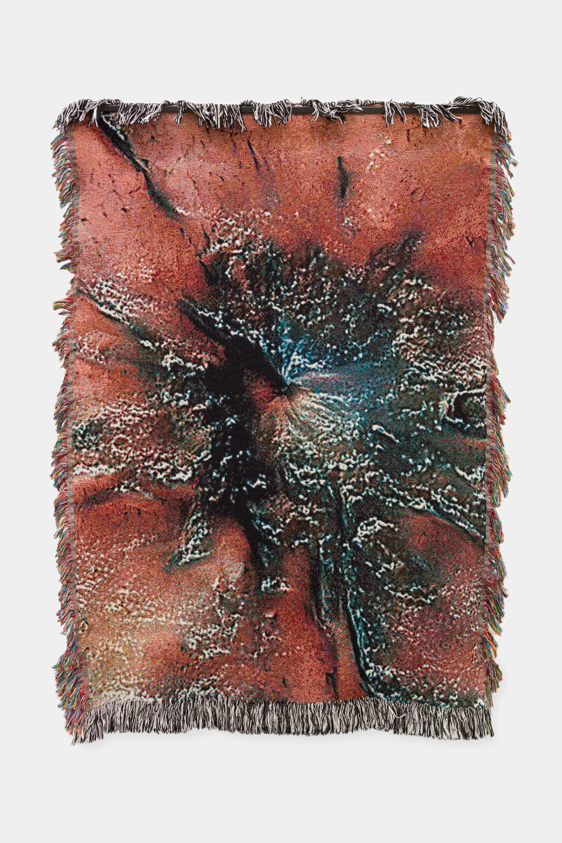 A textured tapestry with an abstract design featuring a burst-like pattern in warm, earthy tones.