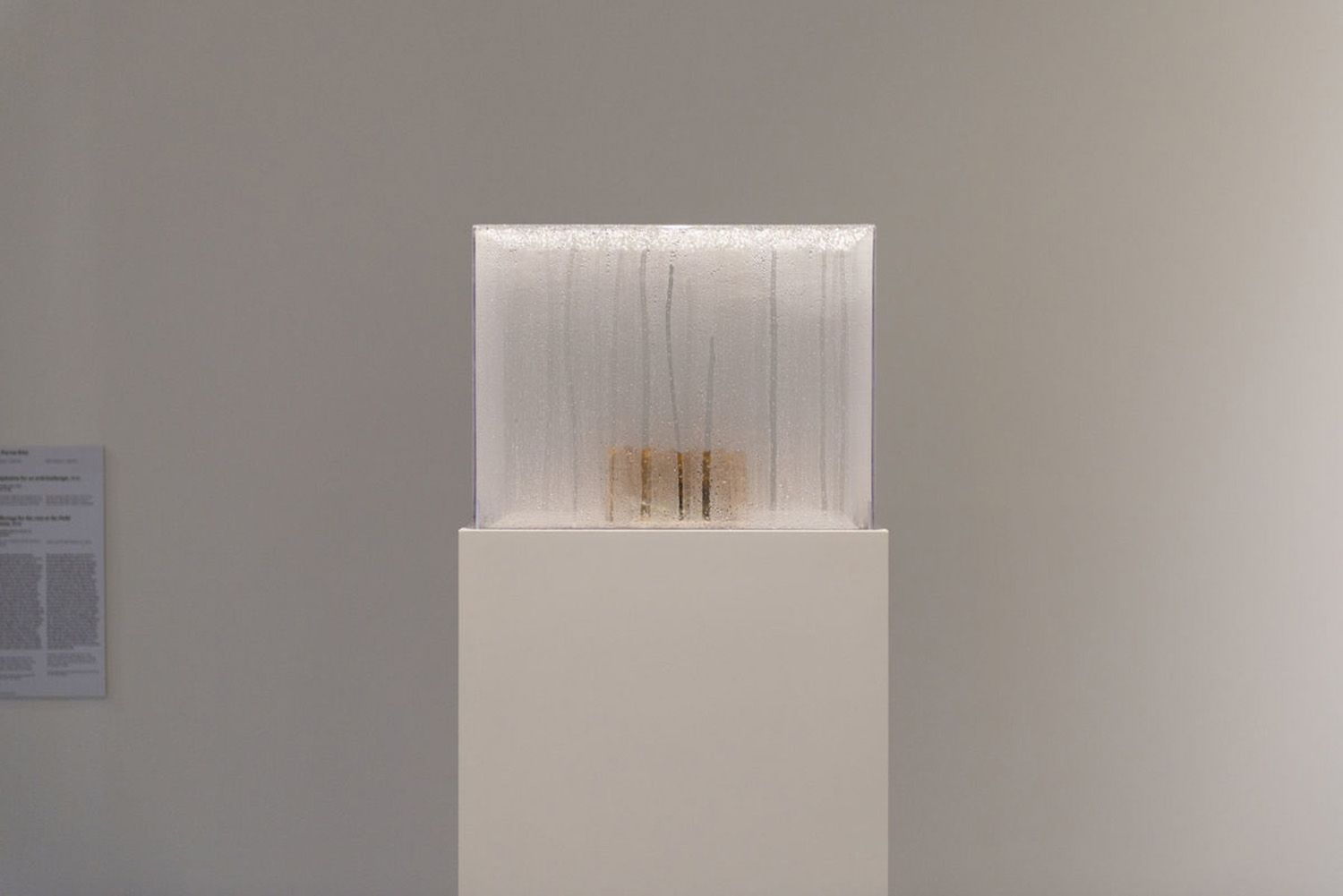 A framed piece featuring a handprint on a delicate white cloth set inside a wooden box.