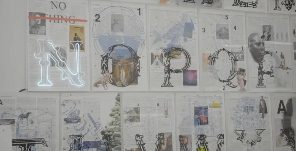 Rows of newspaper pages, adorned with overdrawings, are carefully displayed on a wall, telling a visual story.