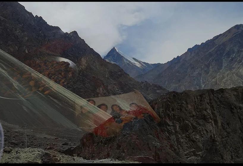 A mountain range layered by a transparent family photo.