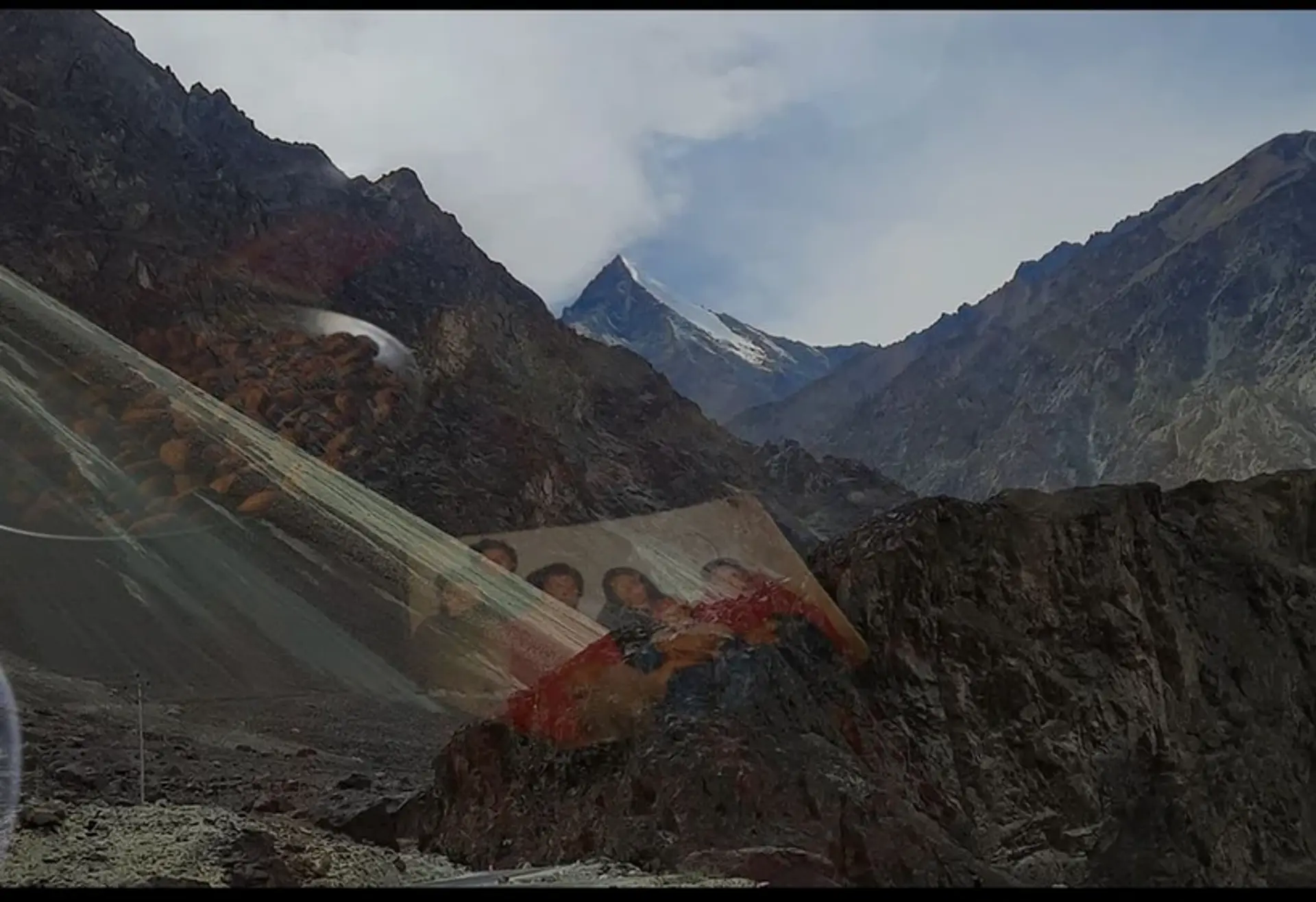 A mountain range layered by a transparent family photo.