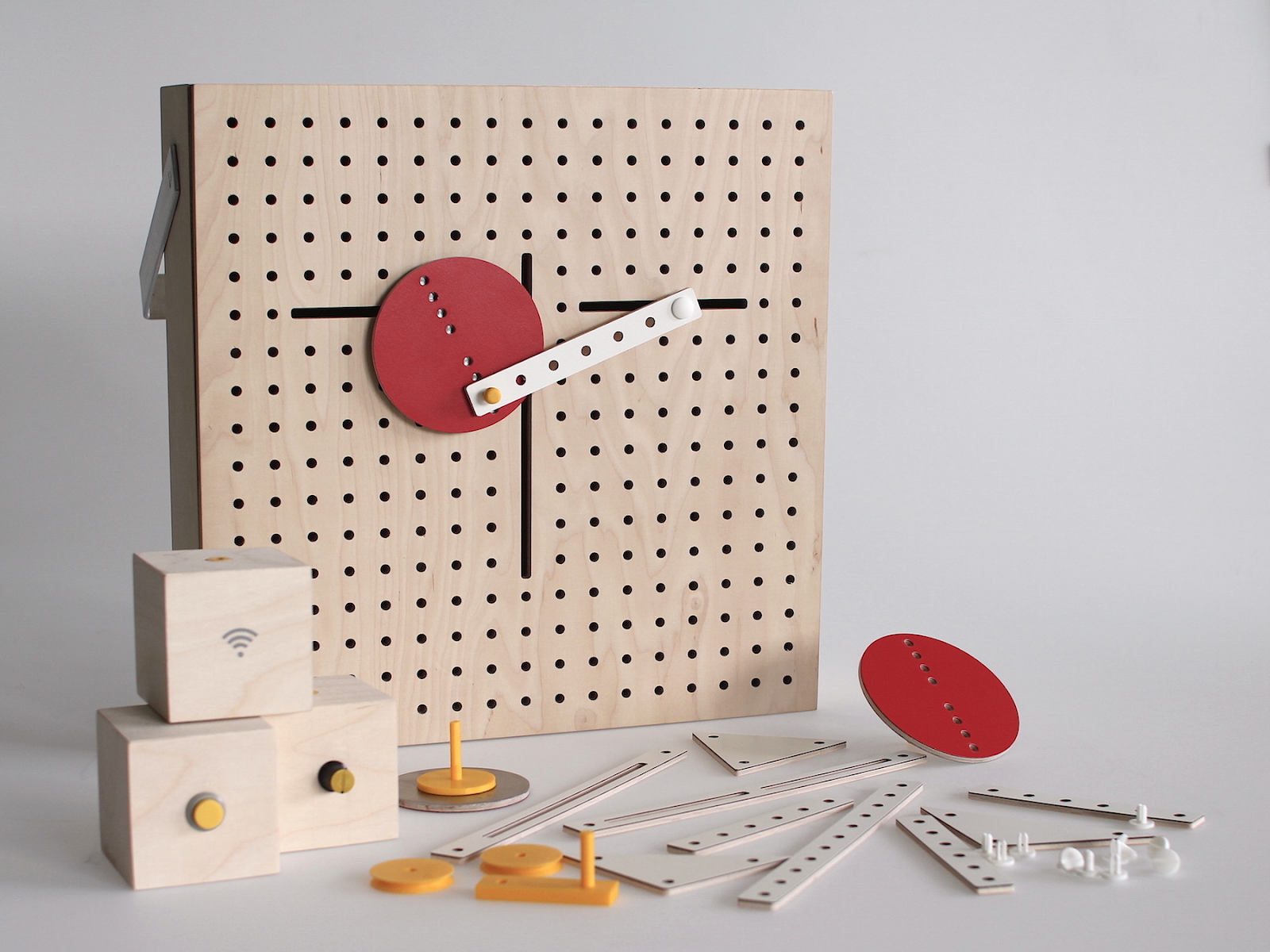 A wooden pegboard holds an array of distinct components well-organized on its surface, demonstrating various elements of t...