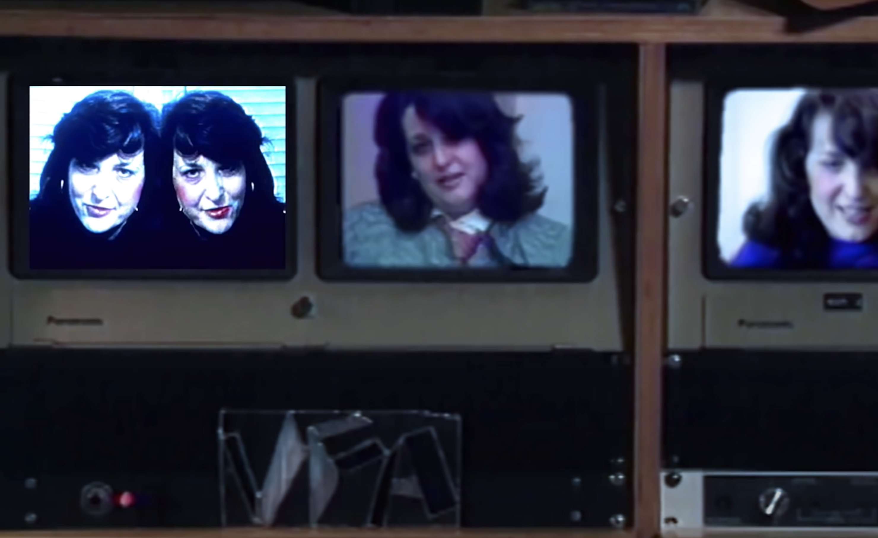 An image from "Electronic Diaries" featuring Lynn Hershman on a dated electronic device with a background full of retro co...