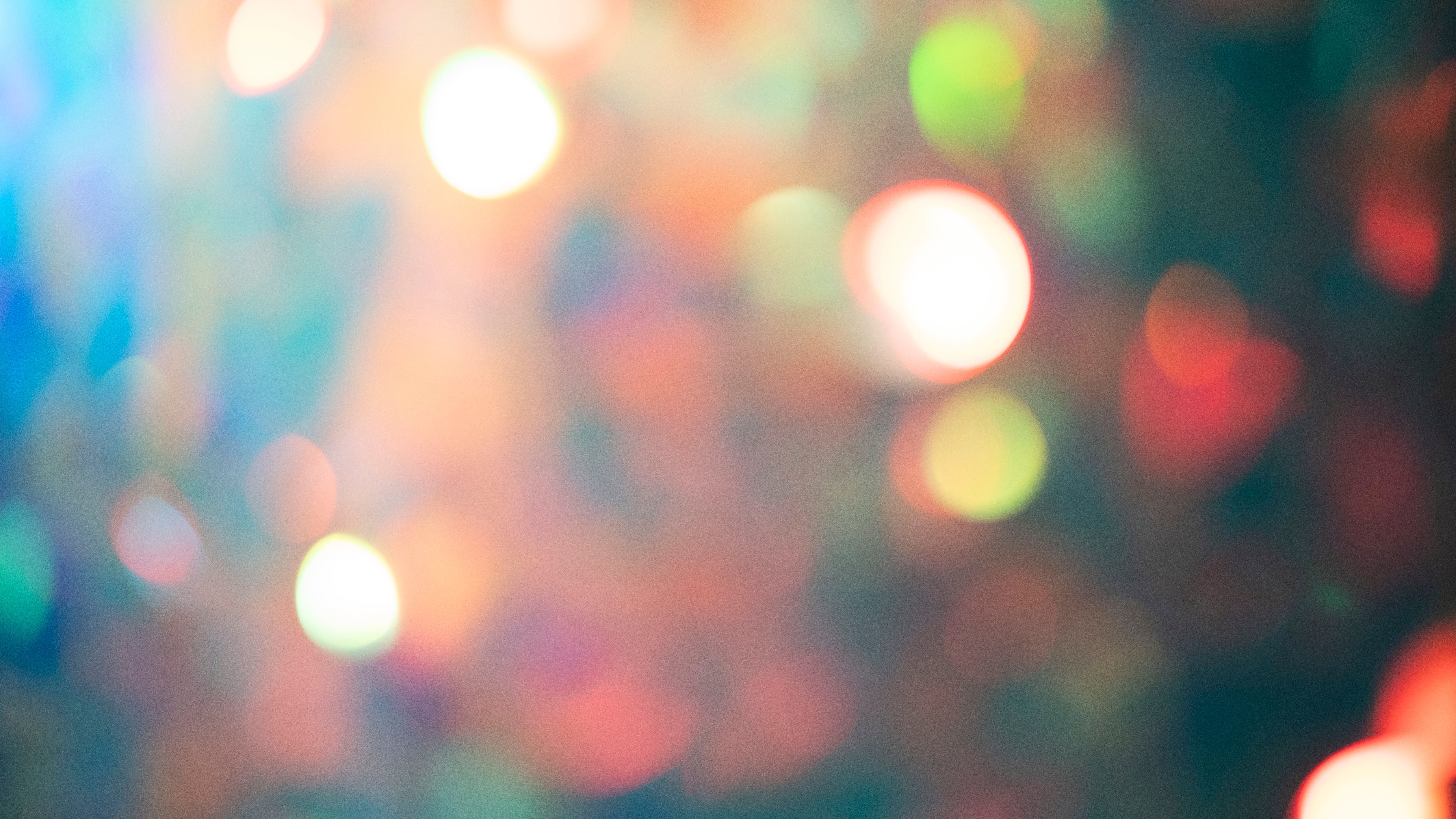 A multi-channel video installation showcasing a blurry amalgamation of lights predominantly in pink hues.