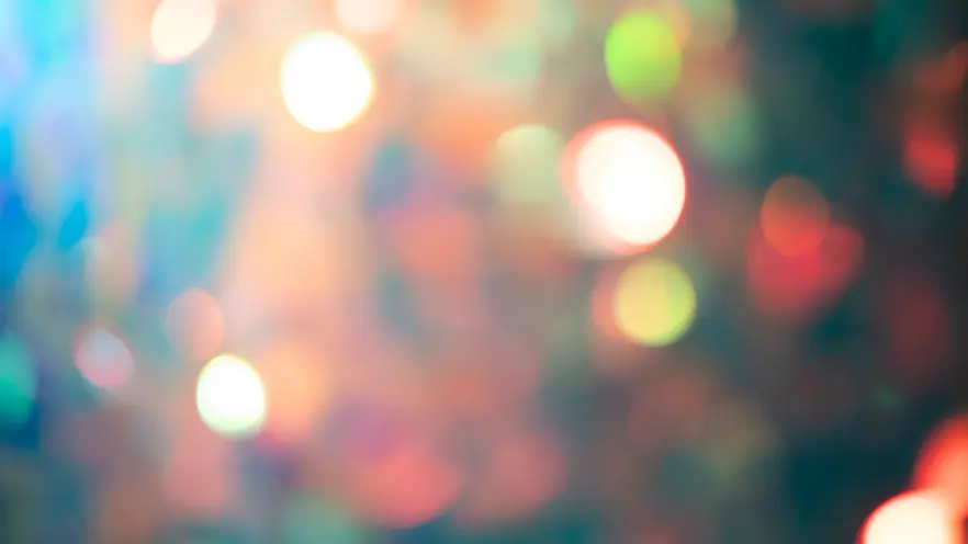 A multi-channel video installation showcasing a blurry amalgamation of lights predominantly in pink hues.