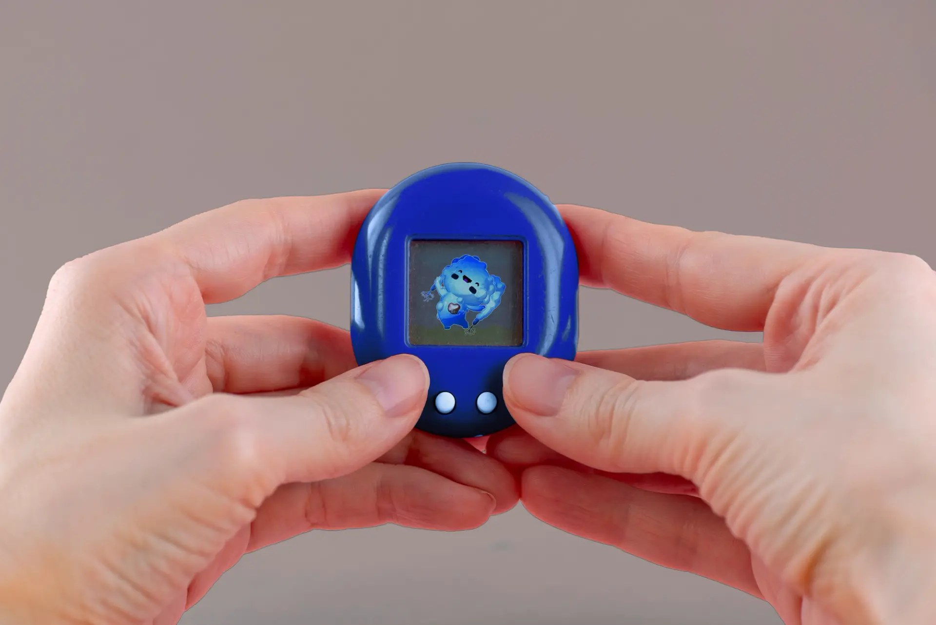 Hands holding a small, blue digital pet device with an animated blue character on the screen.