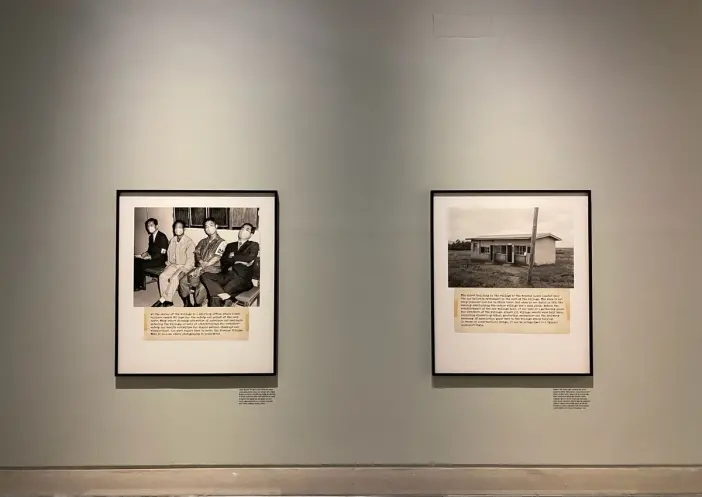 Two vintage photographs displayed in a gallery. One frame captures four individuals, while the other depicts a quaint buil...