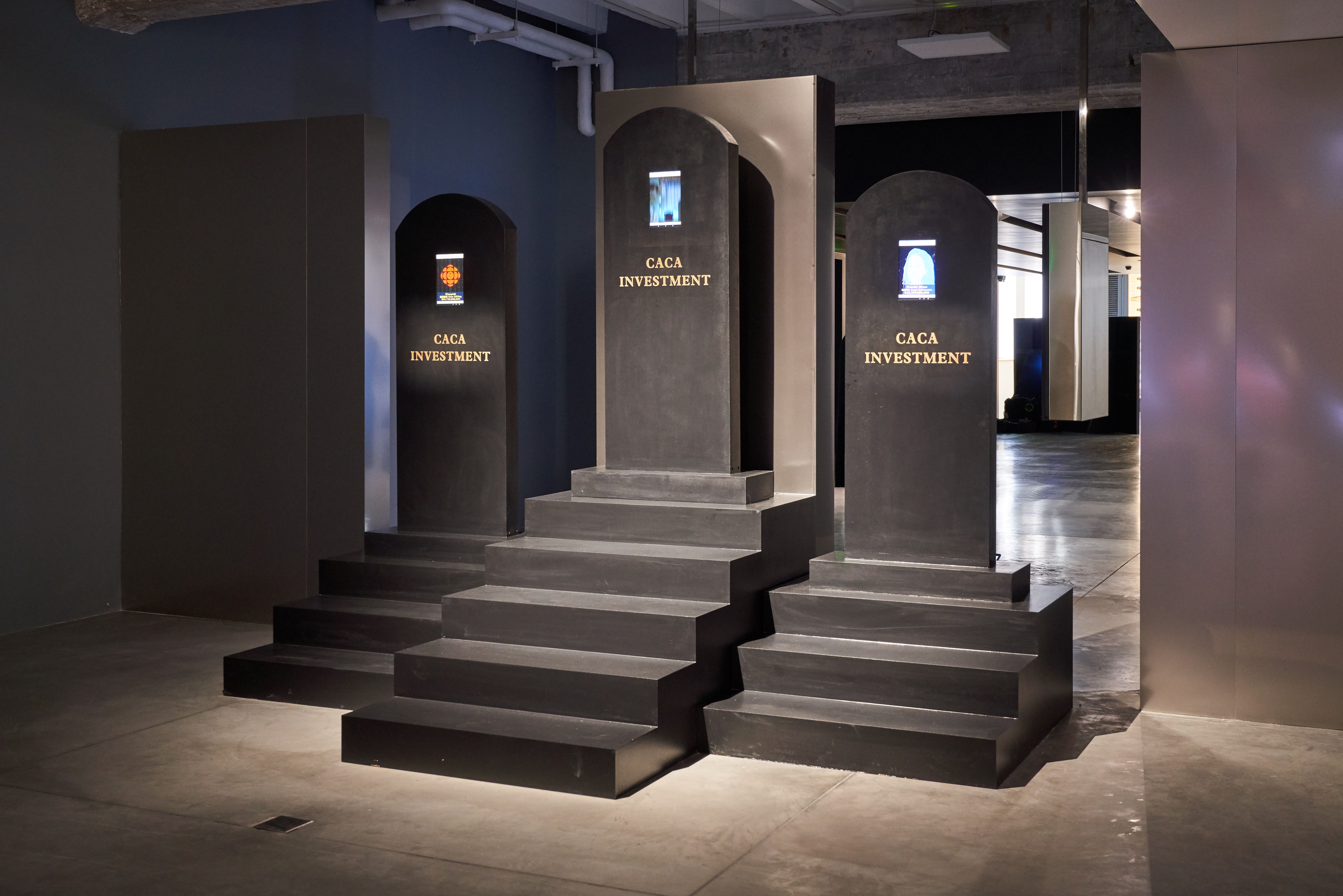 Archways with screens displaying logos and text.