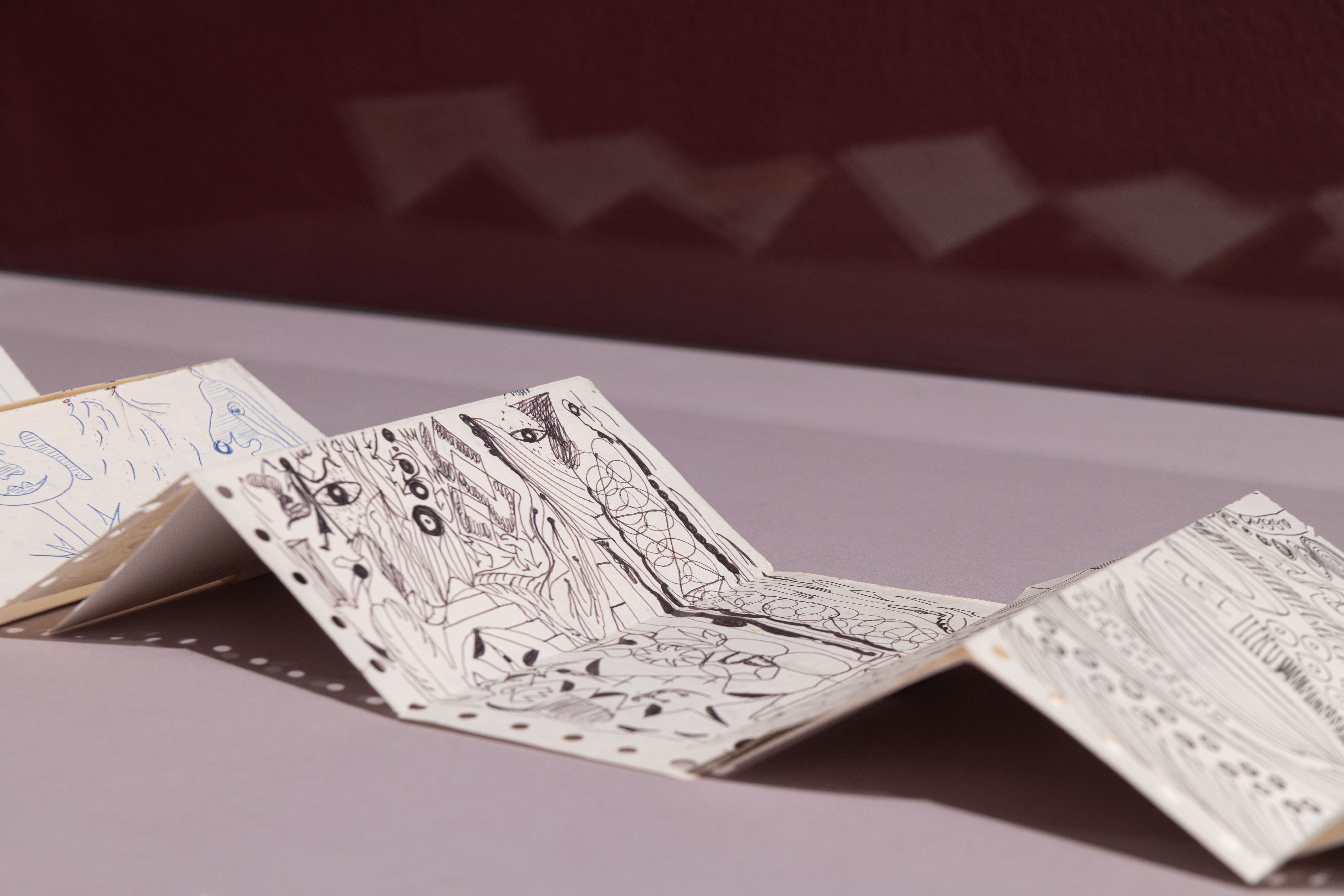 An intricate doodle art depicted on a folded, aged printer paper.