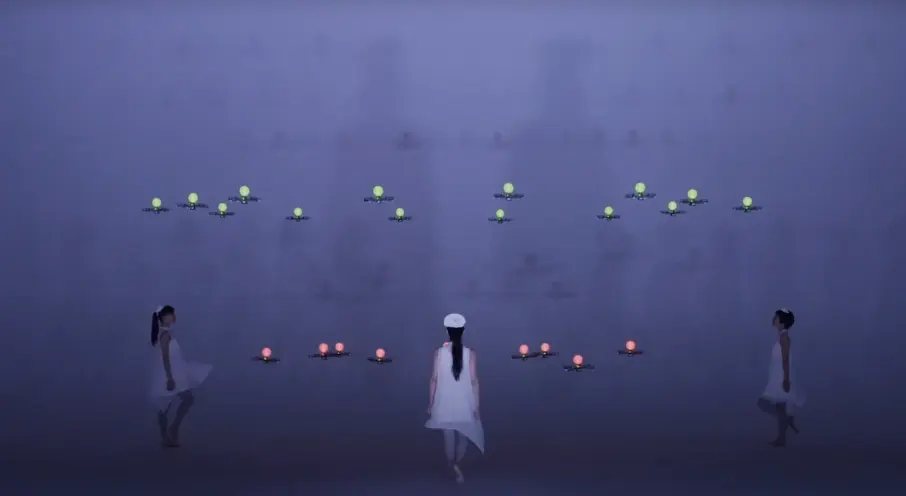 Three people in white attire stand in a triangular arrangement, each surrounded by devices that resemble drones glowing wi...