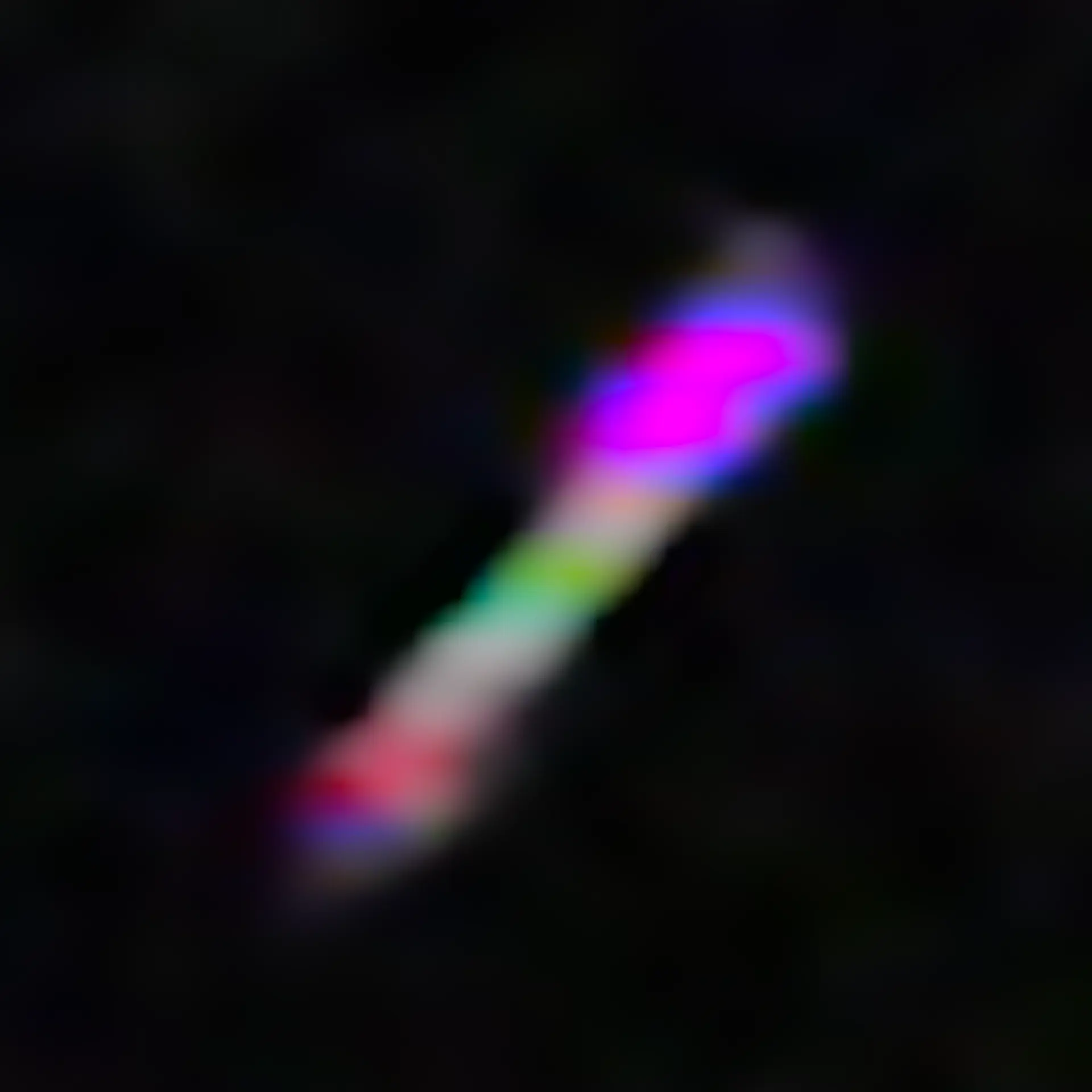 A blurry, multicolored form contrasts dramatically against a deep black background, creating a sense of vibrant movement a...