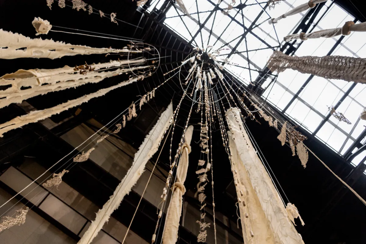 View from the center of a massive windchime installation, shot from a worm's eye view.