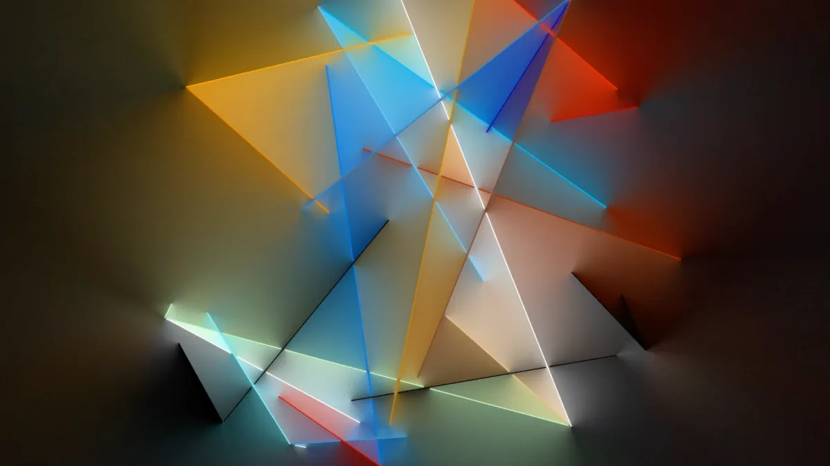 Illuminated lines forming geometric shapes in blue, yellow, red, and green on a black background.