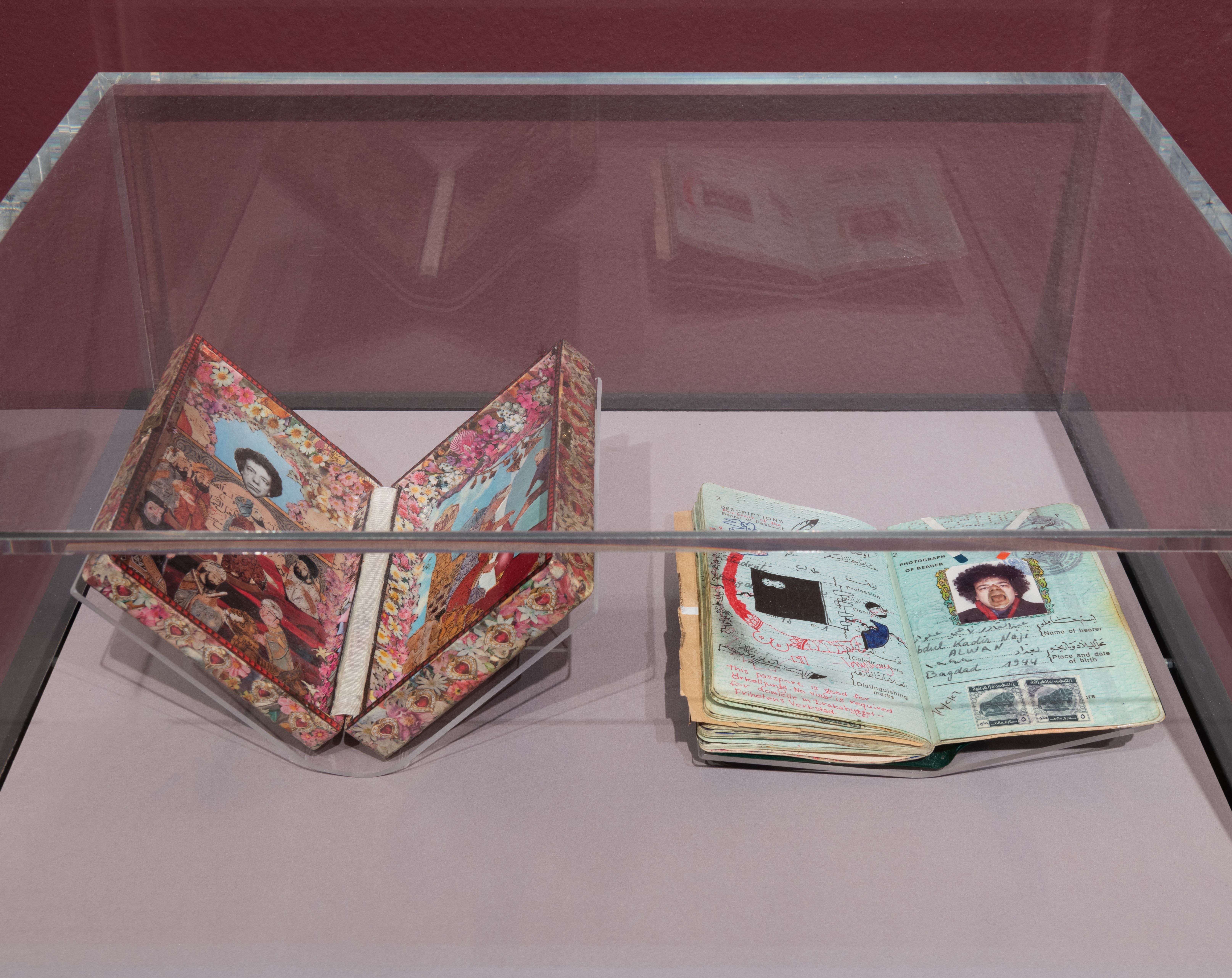 A doodled passport and an assortment of vintage photographs are arrayed within an open box adorned with decorative floral ...