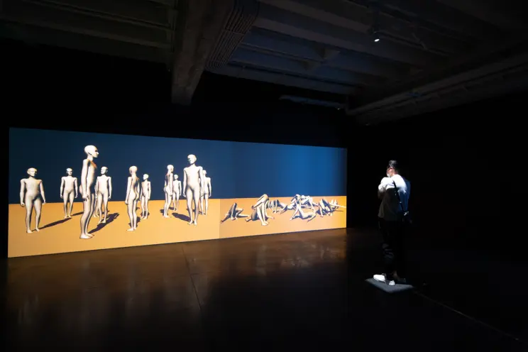 An expansive art piece depicting standing white human forms on the left side and reclining ones on the right, set against ...