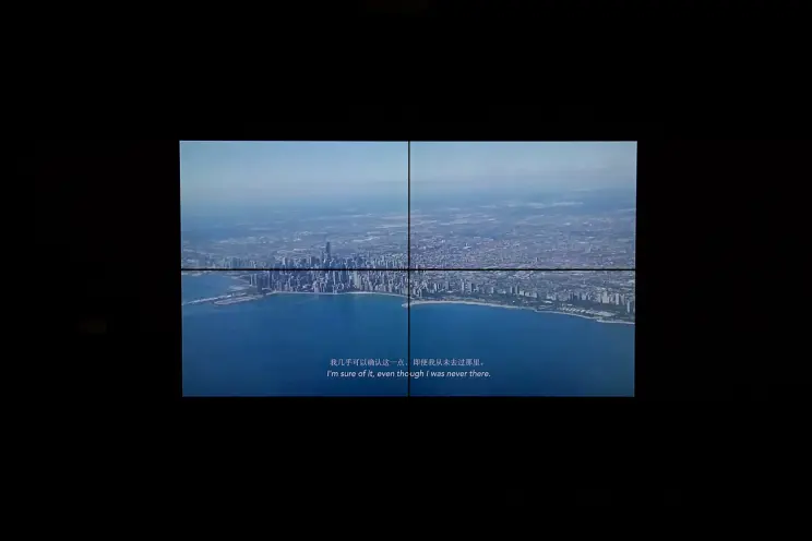 Two-part video screen showing a cityscape with subtitles.