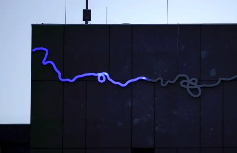 A black billboard featuring a horizontal line that bends subtly, transitioning from blue to grey, akin to a loading progre...