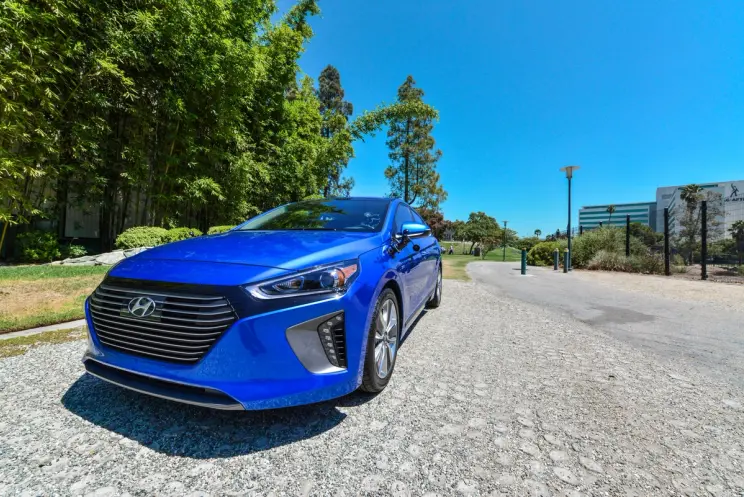 A blue Hyundai car parked outdoors under a clear sky.