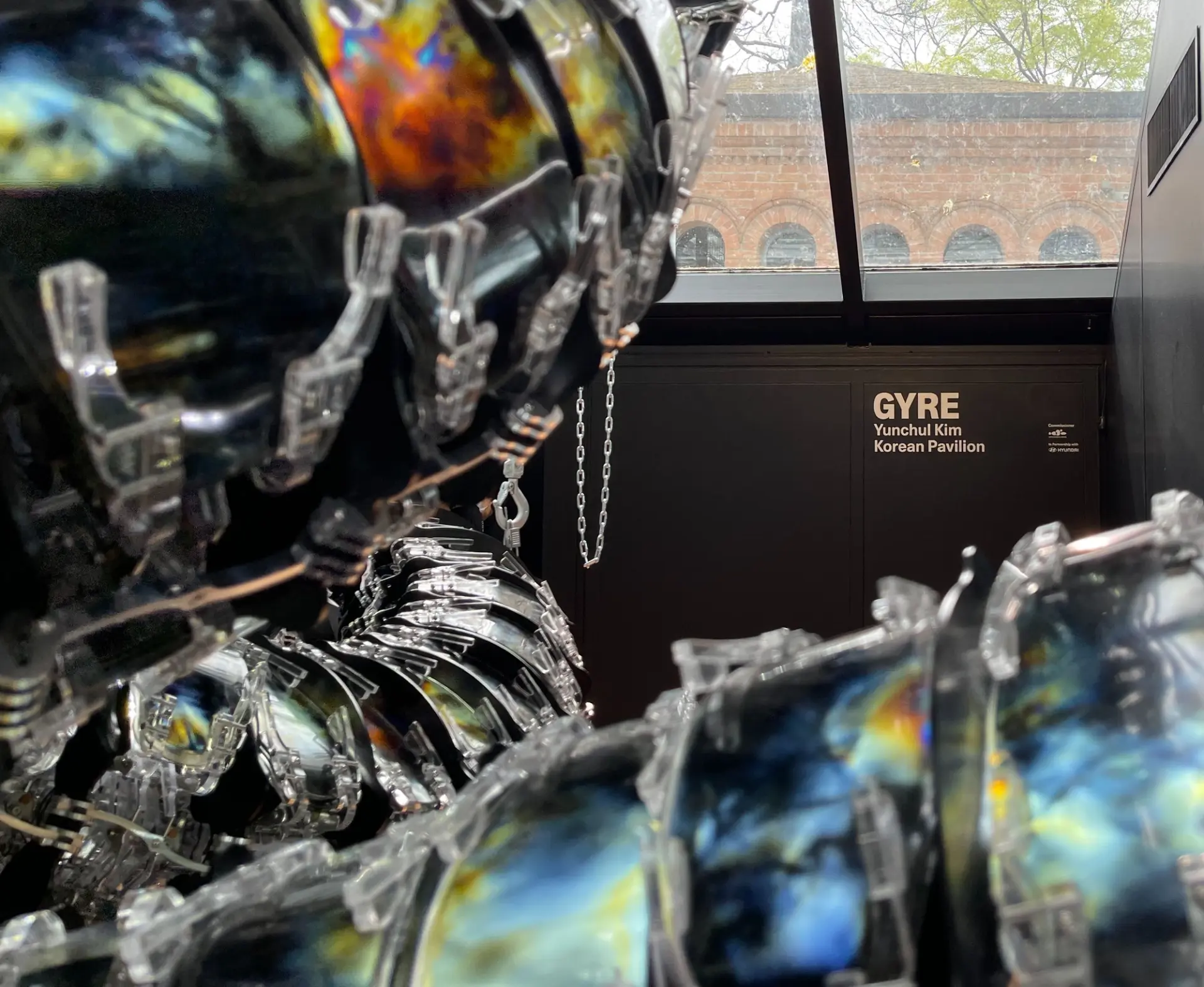 An upclose installation fragment next to a sign reading "GYRE: Yunchul Kim".
