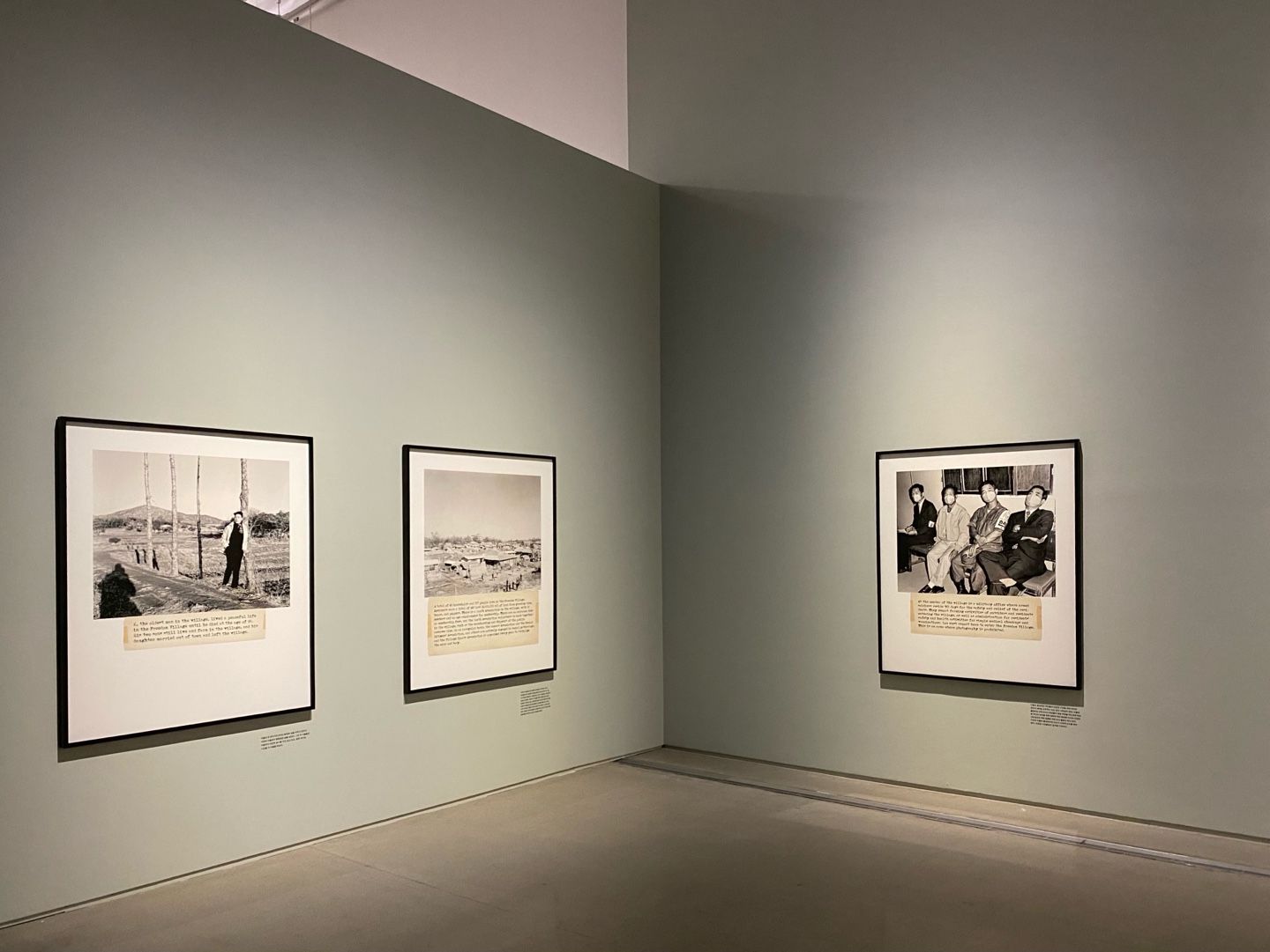 An exhibition space at MMCA Seoul showcasing a series of framed vintage photographs with accompanying text, arranged order...