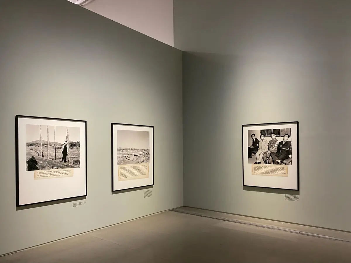 An exhibition space at MMCA Seoul showcasing a series of framed vintage photographs with accompanying text, arranged orderly on a wall.