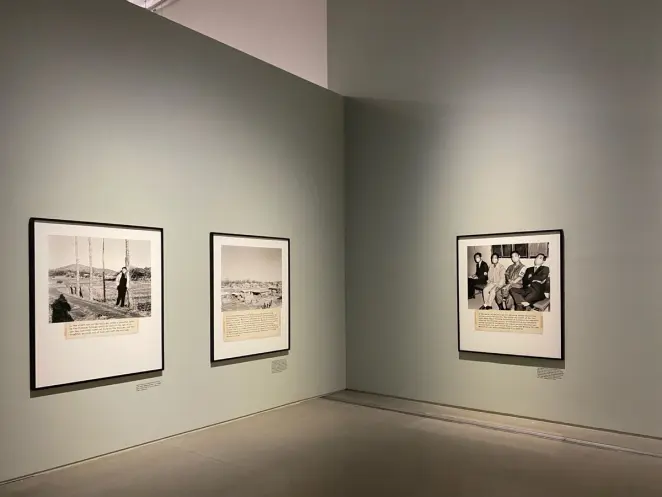 An exhibition space at MMCA Seoul showcasing a series of framed vintage photographs with accompanying text, arranged order...