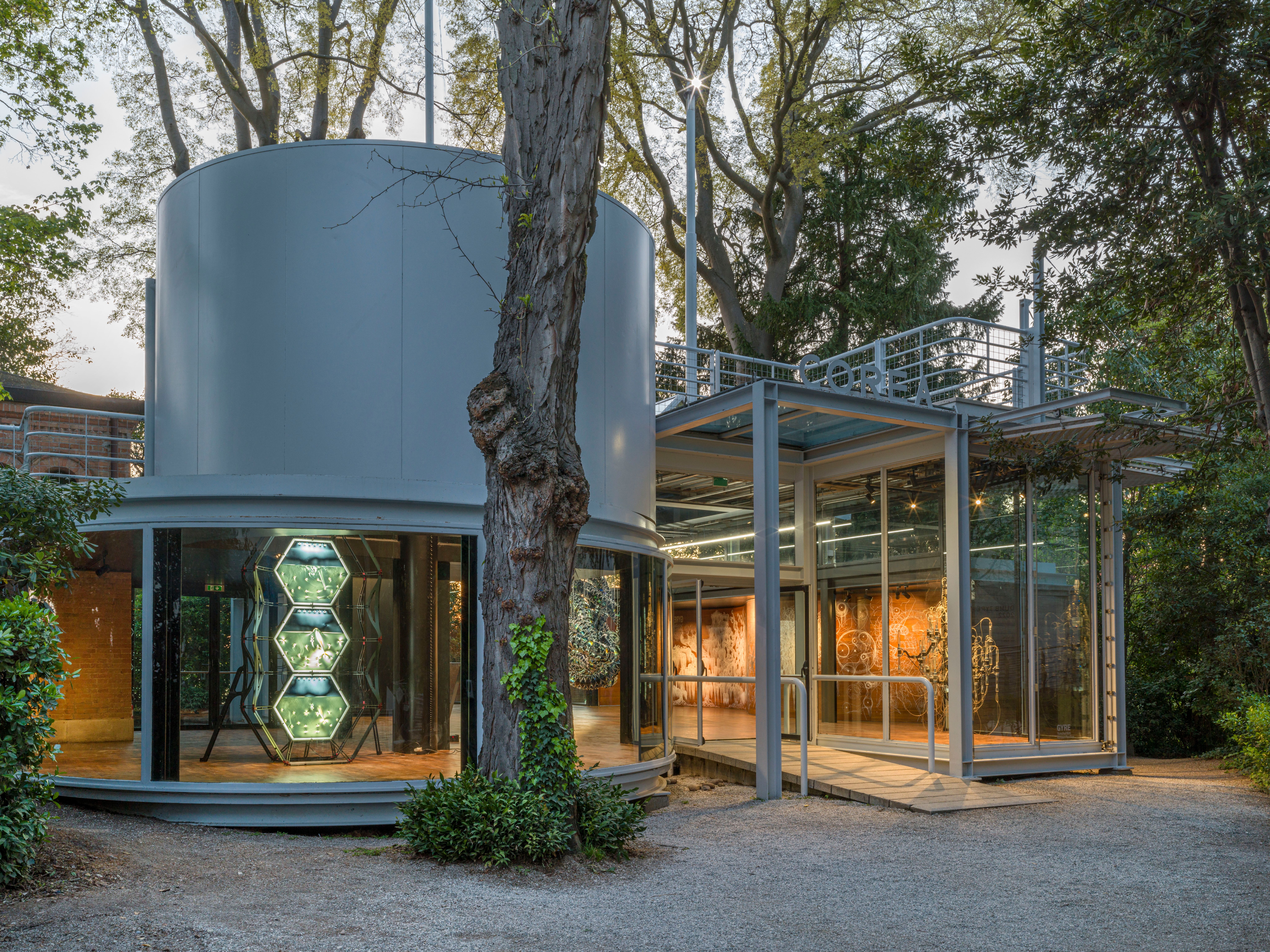 Outdoor view of the Korean Pavilion architecture showcasing cylindrical and square exhibition rooms, separated by a distin...