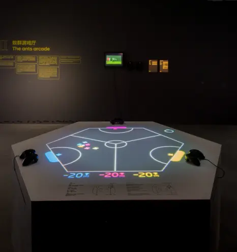 Interactive gaming exhibit with neon lines and arcade controllers.