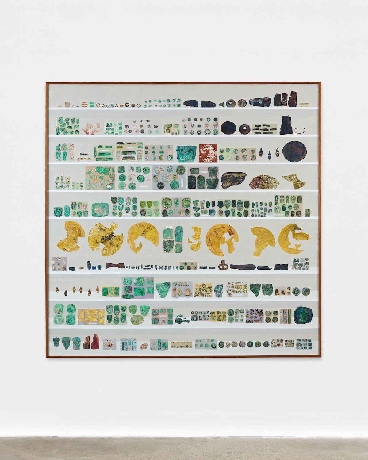 An exhibition at the Peabody Museum displaying a vast collection of 615 artefacts in shades of green and gold, carefully a...
