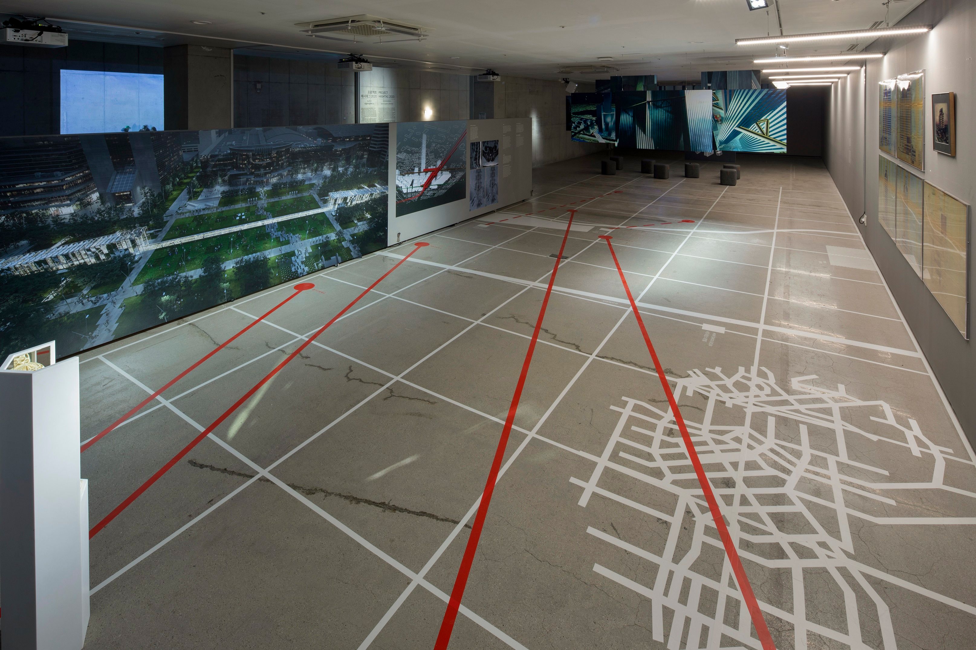 A gallery hall featuring a floor adorned with white and red lines, creating a bold and captivating pattern.