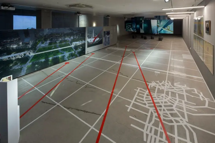 A gallery hall featuring a floor adorned with white and red lines, creating a bold and captivating pattern.