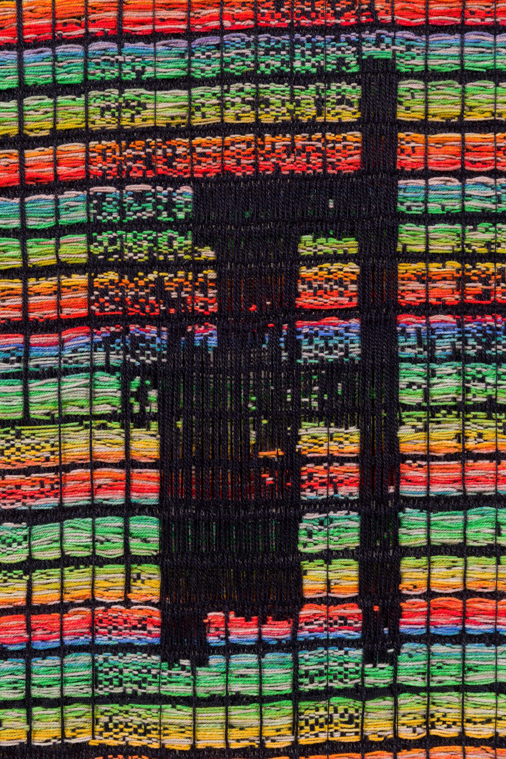 A vibrant hand-dyed wool yarn tapestry, measuring 71 by 41 inches, features a grid-like pattern of rectangles in black, red, green, blue, yellow and white, crafted by Sarah Rosalena.