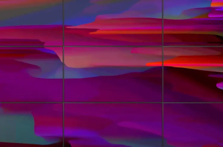 A large abstract artwork split into nine framed pieces, arranged in three rows, features a mix of pink, red, blue, and gre...