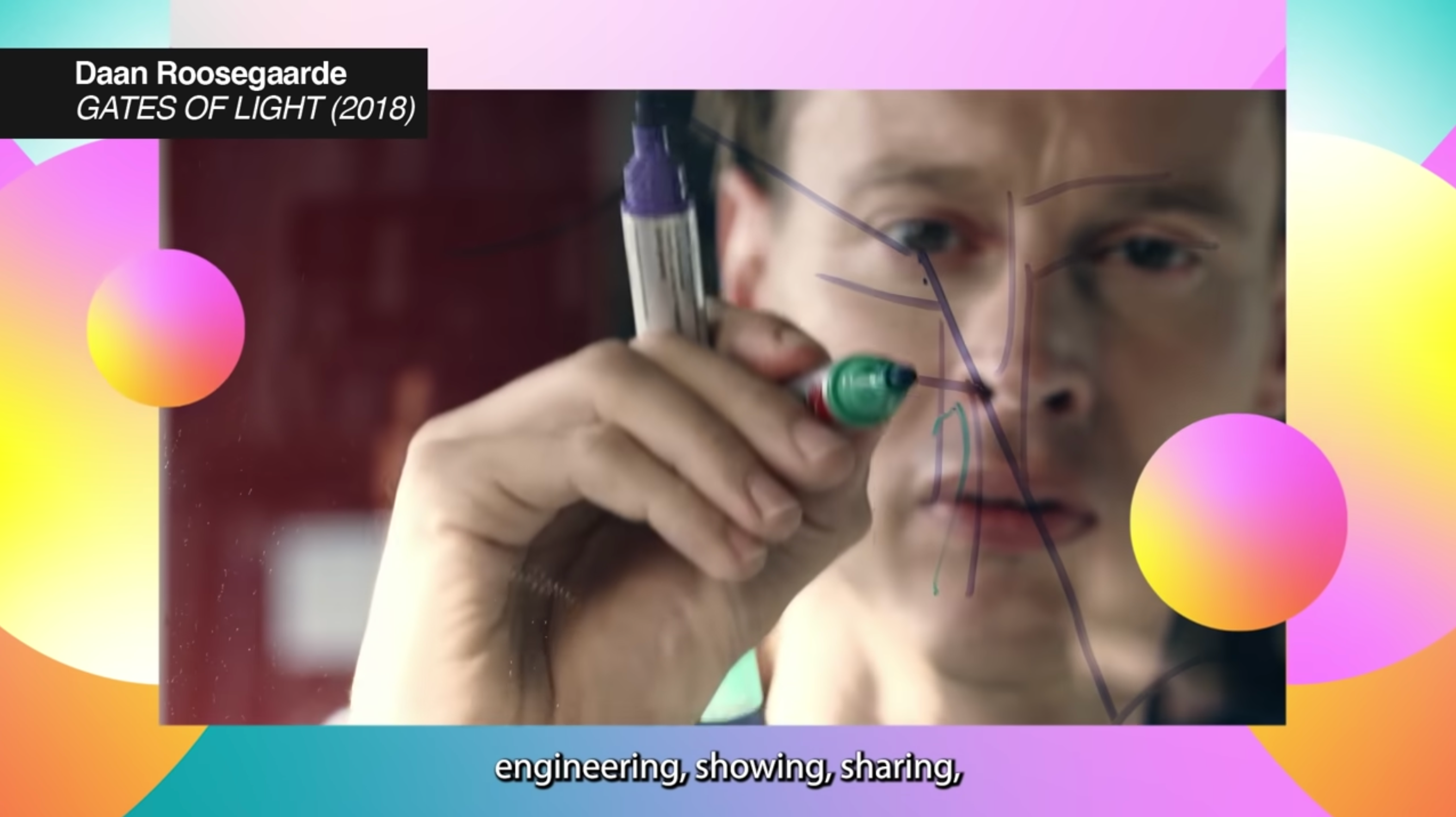 A person drawing on a glass board with a marker, the caption "Daan Roosegaarde GATES OF LIGHT (2018) engineering, showing,...