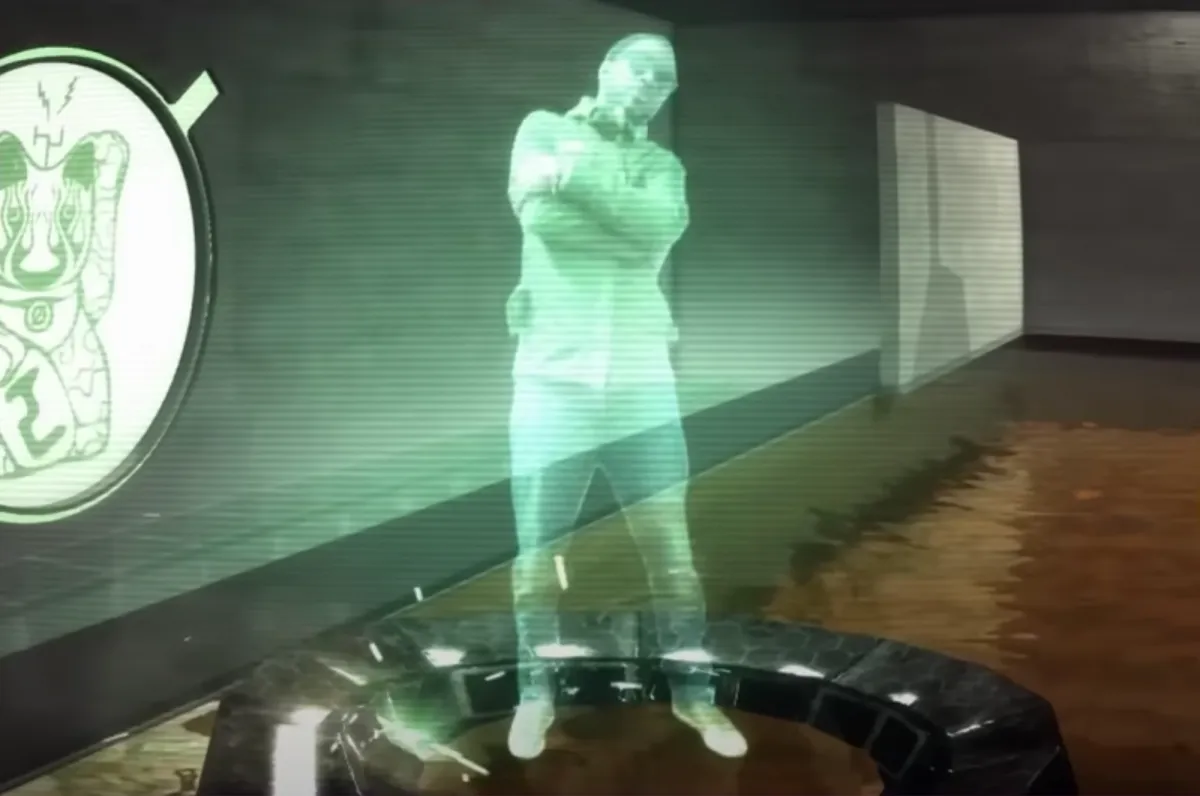 A green-tinted hologram of a person displayed in a futuristic virtual space.
