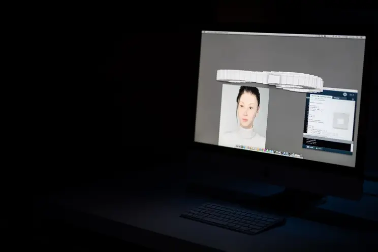 Computer screen with a 3D model of a face and keyboard.