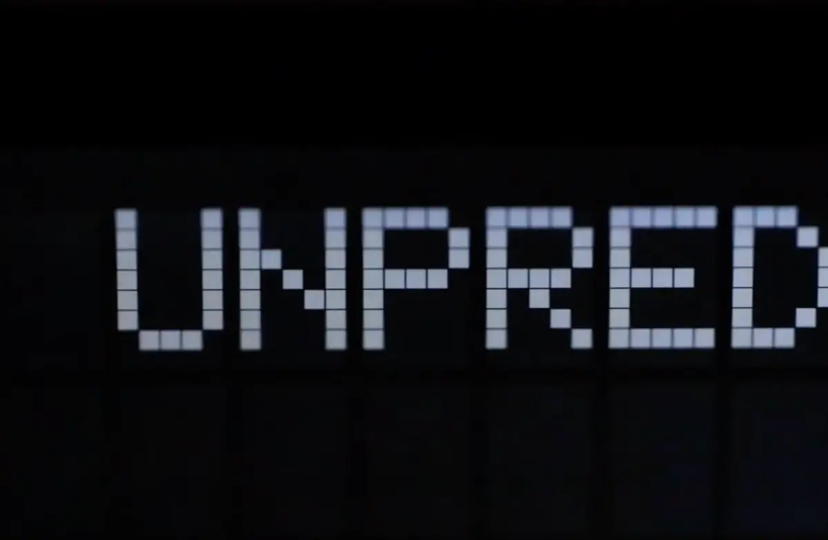 A black background featuring the word "Unpred", constructed from an array of small white squares, showcasing a typographic design.