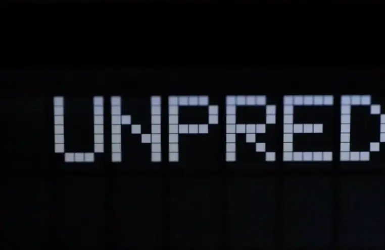 A black background featuring the word "Unpred", constructed from an array of small white squares, showcasing a typographic...